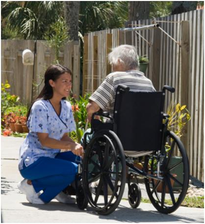 3Hs caregiver walking with an elderly client in a garden